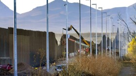 Crews construct a section of border wall in San Bernardino National Wildlife Refuge, Tuesday, Dec. 8, 2020, in Douglas, Ariz.