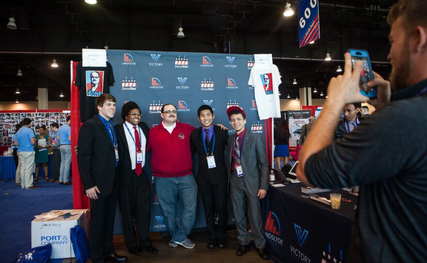 Fans pose for photographs with Ken Bone, who became a social media star after asking a question during the second presidential debate in 2016, in the Exhibitor Hub. Bone was representing political software company Victory Holdings.