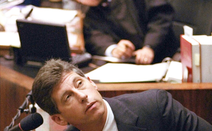 FILE - Los Angeles Police Department Det. Mark Fuhrman, foreground, and Superior Court Judge Lance Ito, rear, crane their heads to look at an overhead monitor during the O.J. Simpson double-murder trial, Friday, March 10, 1995, in Los Angeles.