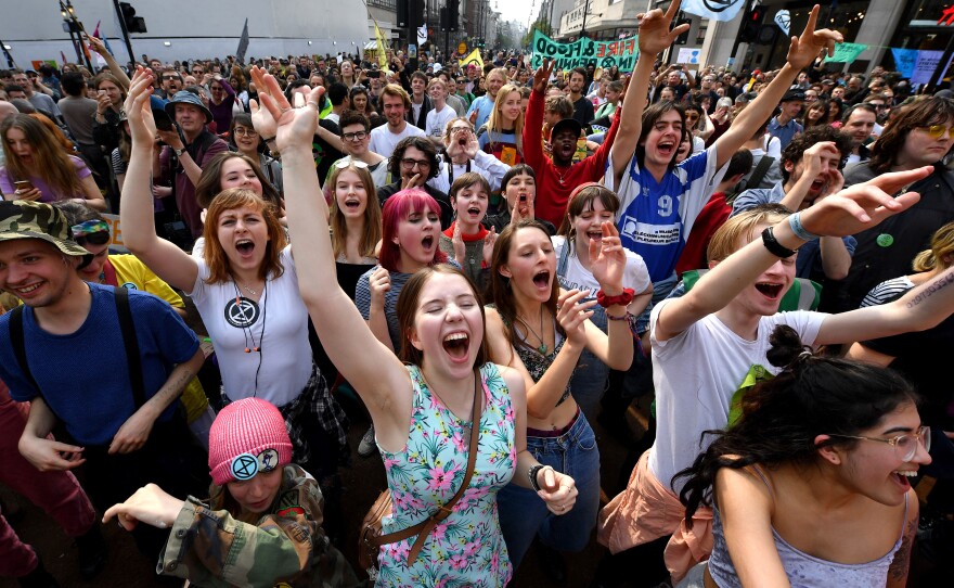 Activists call for government action on climate change in the middle of Oxford Circus on Wednesday in London. Now in their third day of action, protests have blocked a number of key junctions in central London.