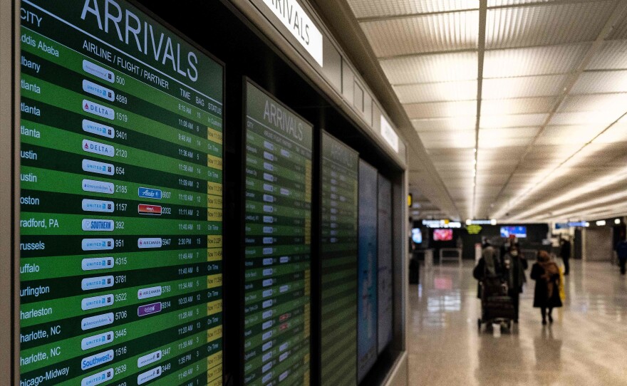 Travelers exit the International Arrivals area at Dulles International Airport in Dulles, Virginia, on Monday. The Biden administration is banning travel for non-U.S. citizens from several African countries over concerns about the omicron variant.