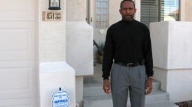 Thad Salter stands in front of the home he bought for $300,000 in 2006. The house in Maricopa, Ariz., is now appraised at $125,000.