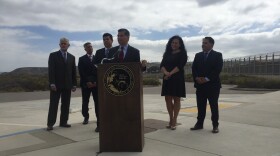 California Attorney General Xavier Becerra announces a lawsuit against President Donald Trump's border wall at Border Field State Park, Sept. 20, 2017. 