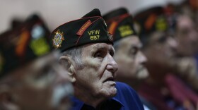 Members of the Veterans of Foreign Wars look on Monday as President Obama speaks during the group's national convention in Reno, Nev. Republican Mitt Romney was scheduled to speak to the group on Tuesday.