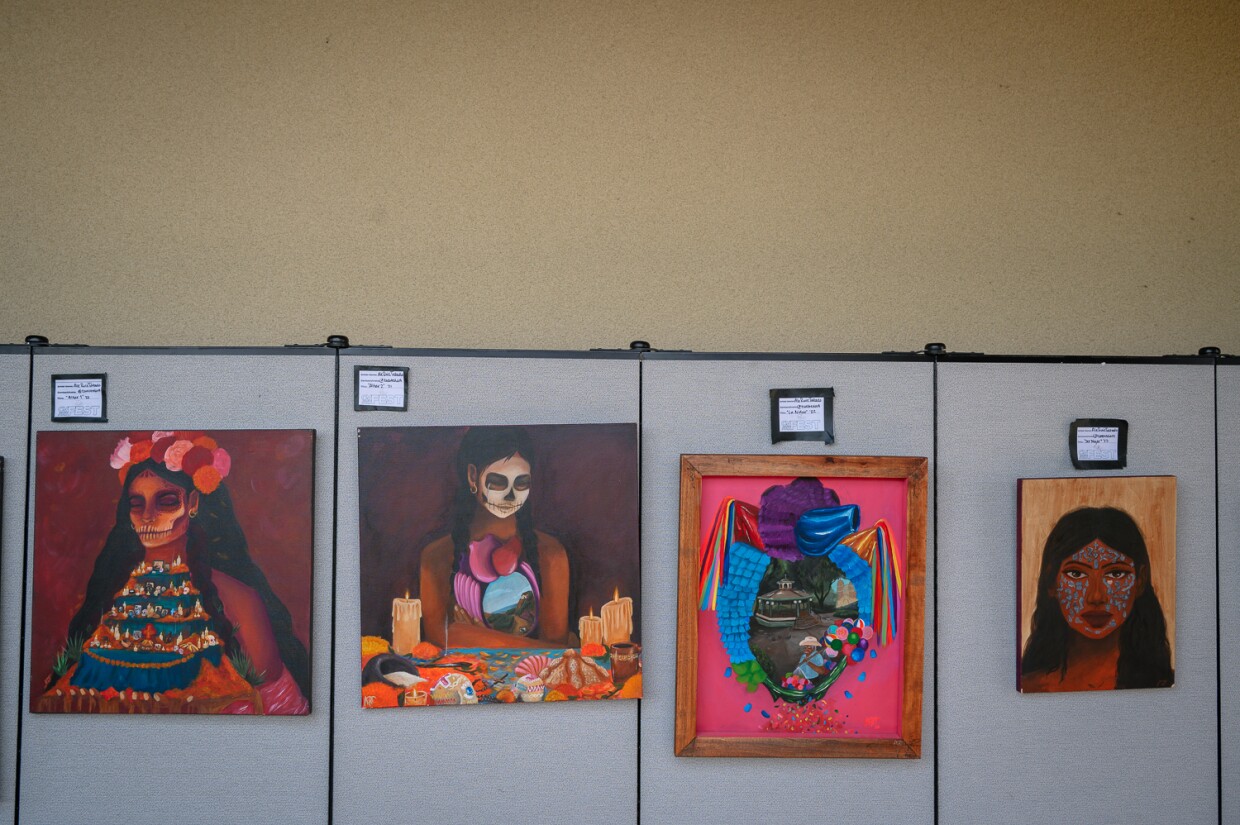 Visitors walk through an exhibit of paintings and other artwork at the inaugural Chula Vista Art Fest, outside Chula Vista City Hall, on Sept. 30, 2023.