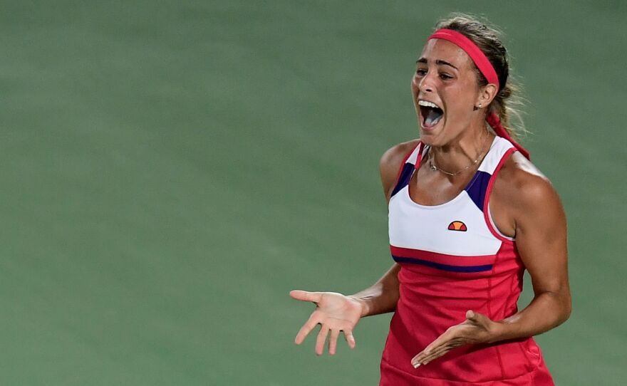 Puerto Rico's Monica Puig reacts after winning her women's singles final tennis match against Germany's Angelique Kerber at the Olympic Tennis Centre of the Rio 2016 Olympic Games in Rio de Janeiro on August 13, 2016.