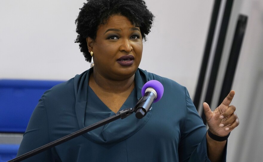 Stacey Abrams speaks during a church service in Norfolk, Va., on Oct. 17. A political organization led by the Democrat is branching out into paying off medical debts. Fair Fight Action said it's donating $1.34 million from its political action committee to wipe out debt owed by 108,000 people in Georgia, Arizona, Louisiana, Mississippi and Alabama.