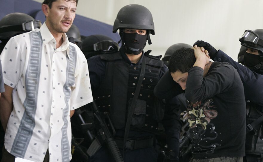 Alleged drug dealers of the Sinaloa cartel are escorted by policemen in Mexico City following their arrests earlier this year.