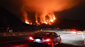 Motorists make their way along a road as the Ranch Fire burns, Thursday, Aug. 13, 2020, in Azusa, Calif. 