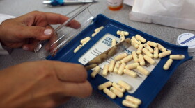 A pharmacy manager counts out the correct number of pills to fill a prescription  in Miami.
