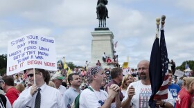 Protesters gather and hold signs during the Tea Party Express rally on September 12, 2009 in Washington, DC. 