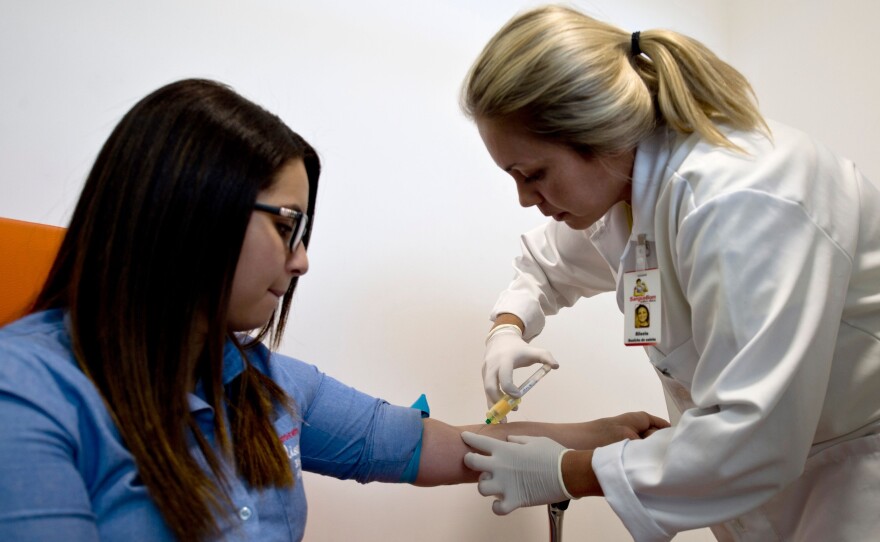 A patient at a Rio de Janeiro clinic has a blood sample taken to check for Zika and other viruses.