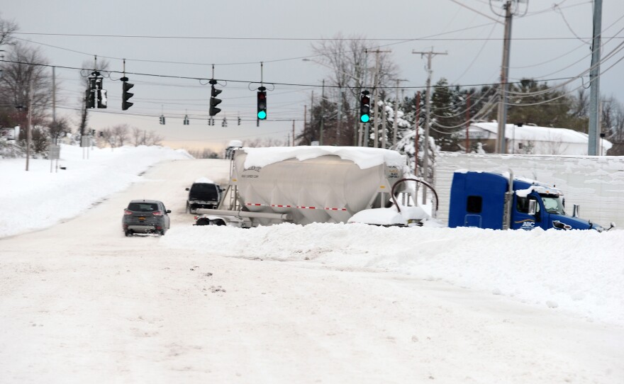Abandoned trucks block lanes along Route 20 after an intense lake-effect snowstorm impacted the area on Saturday in Hamburg, New York.