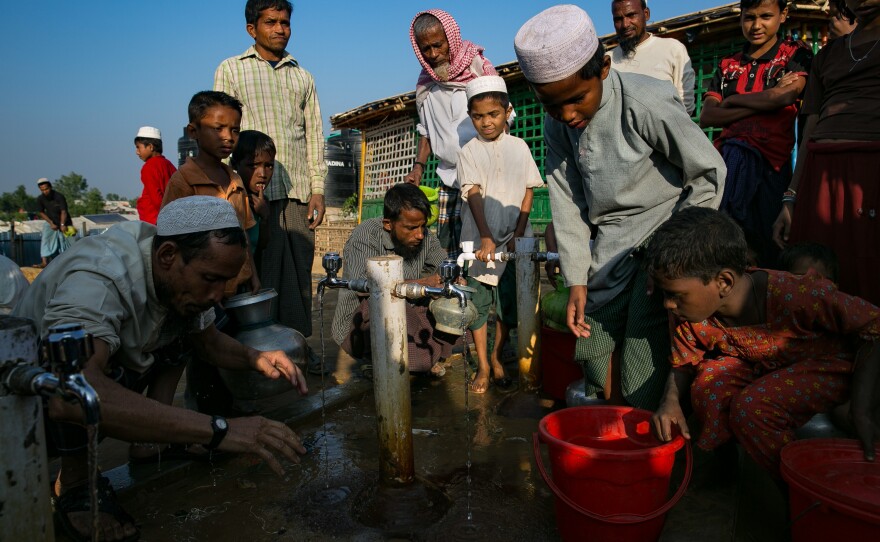 Refugees collect water and wash before prayers.