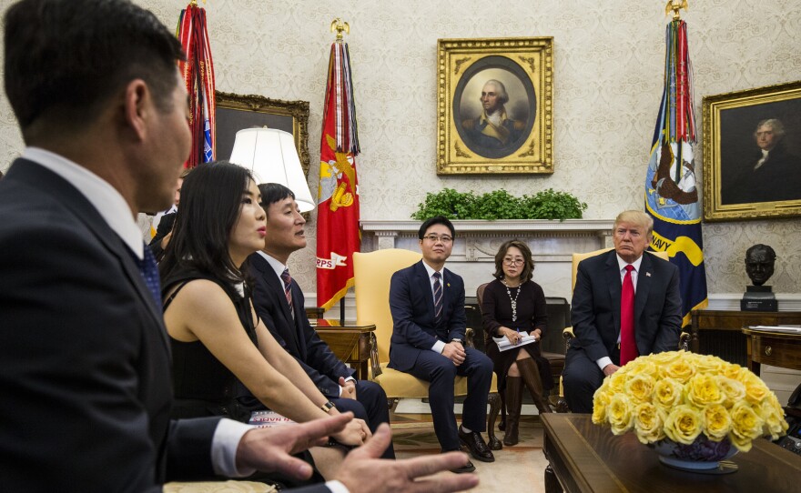 U.S. President Donald Trump meets with Hyeonseo Lee (far left) and other North Korean defectors in the Oval Office of the White House on Feb. 2, 2018.