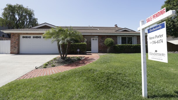 A house for sale sits behind a sign that reads "sale pending" in San Diego, Aug. 14, 2013.
