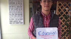 Alex Lopez of Chula Vista holds up a sign showing the most important issue to him in the 2016 election, Jan. 22, 2016.