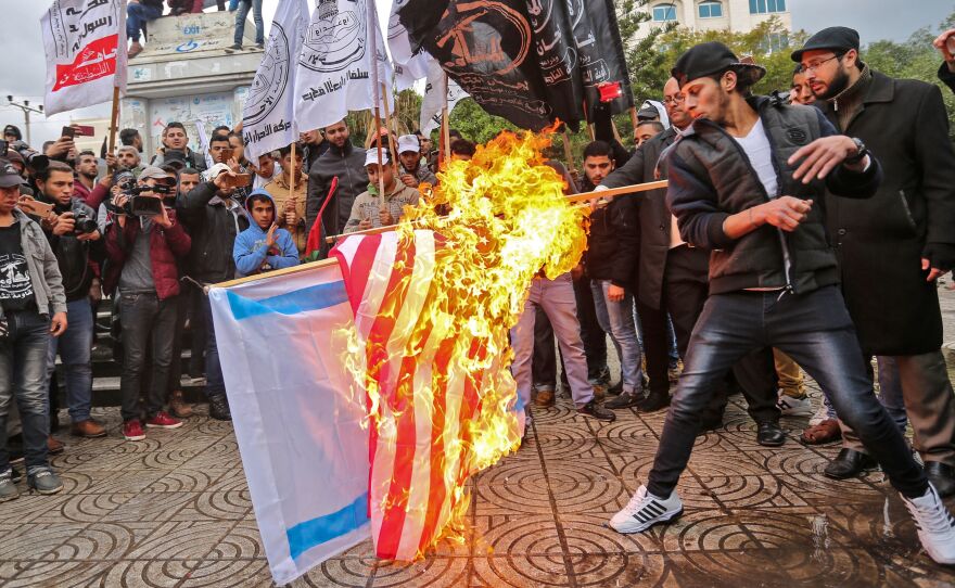 Palestinian protesters burn the U.S. and Israeli flags in Gaza City on Wednesday. President Trump is set to recognize Jerusalem as Israel's capital, upending decades of U.S. policy and ignoring dire warnings from allies.