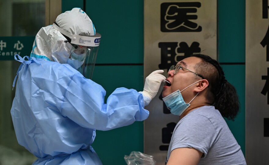 A man gets tested for the coronavirus Wednesday in Wuhan, China, the cradle of the global pandemic. Authorities plan to test the city's entire population after new cases emerged for the first time in weeks, according to state media.