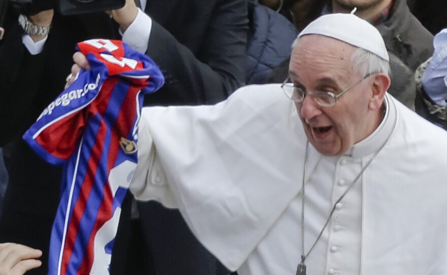 Pope Francis holds a San Lorenzo jersey handed to him at the end of the Easter Mass at the Vatican on March 31, 2013. The pope is an avid fan of the Buenos Aires soccer team.