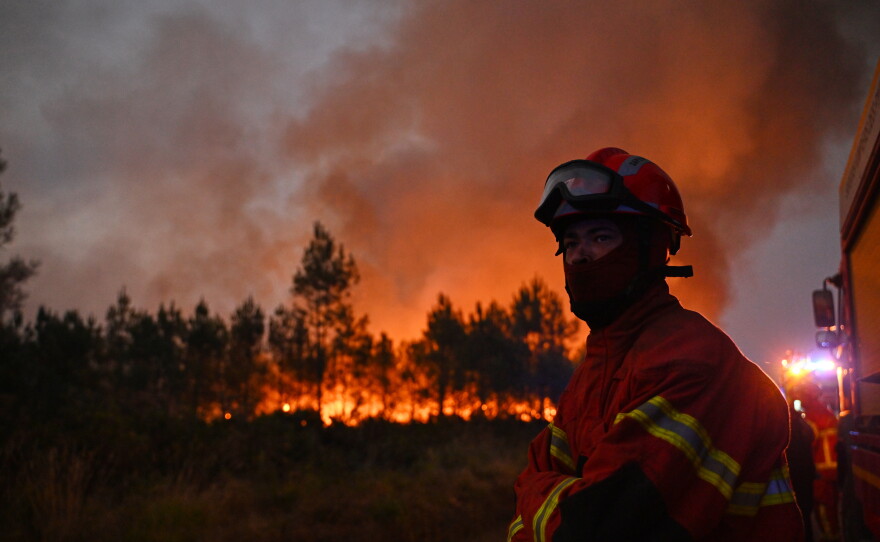 Firefighters battle a blaze outside Lanton, during wildfires in southwestern France, Tuesday, July 28, 2026.
