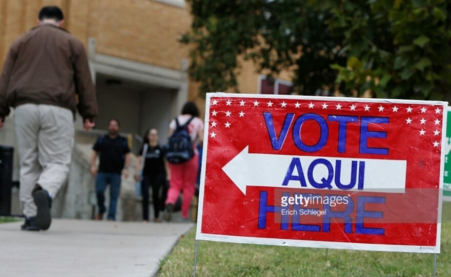 A sign shows the way to a polling station in Austin, Texas. A federal appeals court has knocked down a state voter ID law.