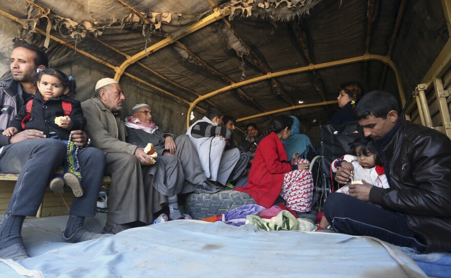 Iraqi civilians are loaded onto a truck Thursday to be taken to safety amid ongoing fighting between the Iraqi security forces and the Islamic State in Ramadi, 70 miles west of Baghdad. More than two weeks after central Ramadi was declared liberated, Iraqi forces are still battling pockets of ISIS militants on the edge of the city.