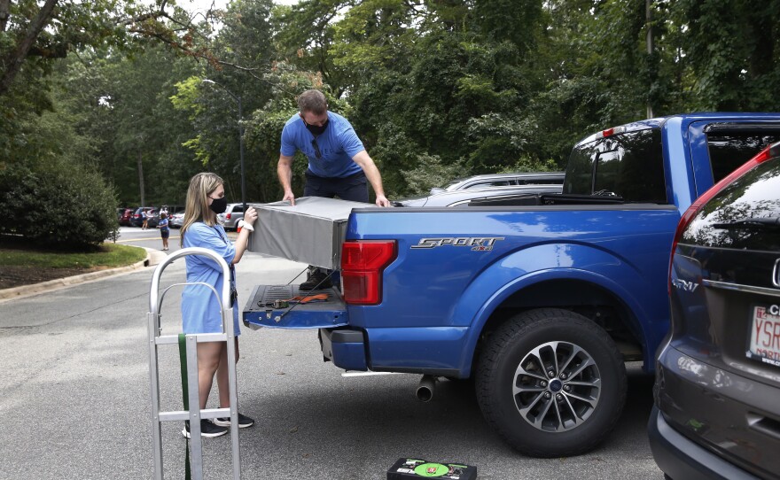Freshman Cameron McClure moves out of her UNC dorm with help from her father, David McClure. "When they gave us the option of going home, we were all just like, it's probably better for us," she says.