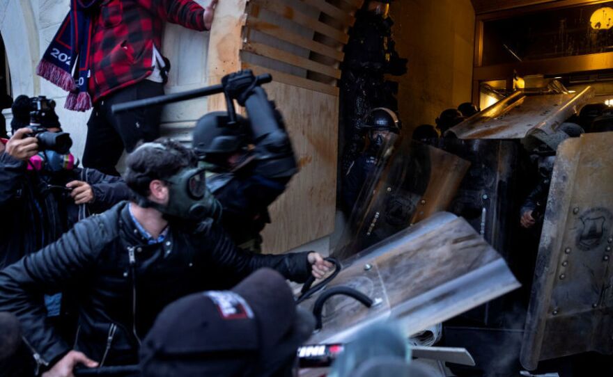 Rioters clash with police and security forces as people try to storm the U.S. Capitol on Jan. 6. The FBI is undertaking a massive investigation to identify and charge hundreds of individuals.