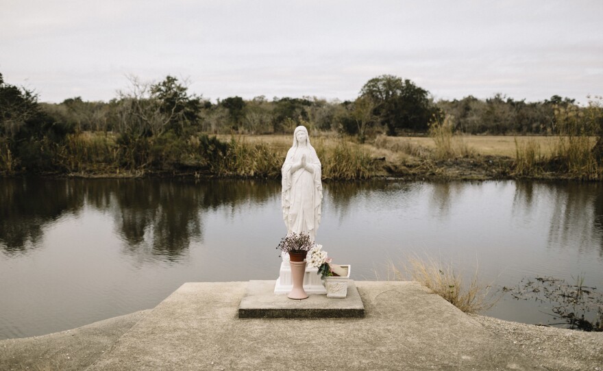 A statue of the Virgin Mary stands on the banks of Bayou Dularge in the tiny unincorporated fishing village of Theriot.