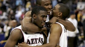 Marcus Slaughter #42 hugs Brandon Heath #1 and John Sharper #15 of the San Diego State University Aztecs after defeating the Wyoming Cowboys 69-64 in the championship of the Mountain West Conference Basketball Tournament on March 11, 2006 at the Pepsi Center in Denver, Colorado. 