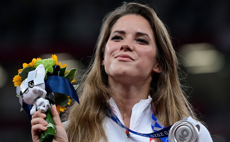 Poland's Maria Magdalena Andrejczyk celebrates her silver medal for the women's javelin throw at the Olympic Stadium in Tokyo on Aug. 7. She auctioned the medal to help fund heart surgery for an 8-month-old.