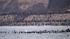 Migrants cross from Morocco into the Spanish enclave of Ceuta, Thursday, July 30, 2026.