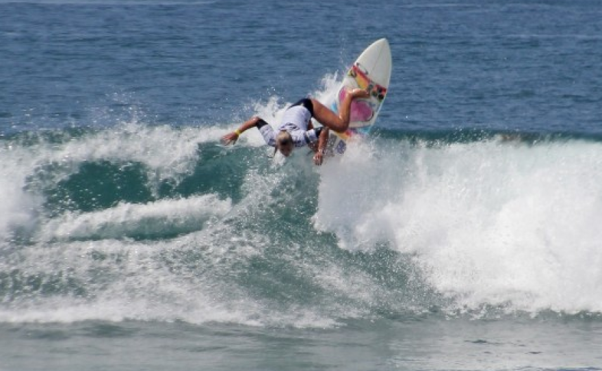 Sage Erickson surfing at Oceanside Pier, 2014. 