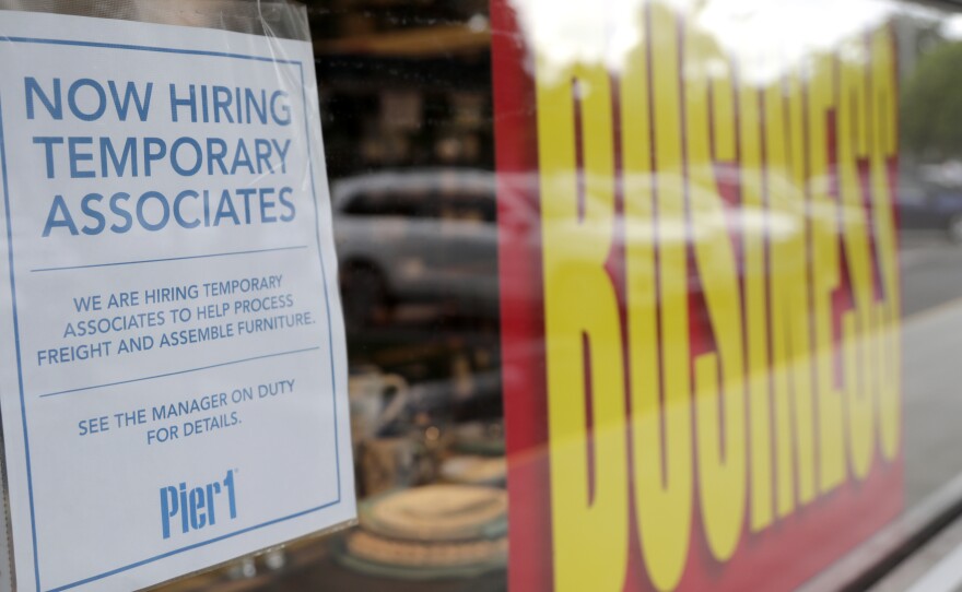 A sign advertises hiring of temporary workers at a Pier 1 store that's going out of business in Coral Gables, Fla. Last week, initial unemployment claims broke a 20-week streak of being above 1 million.
