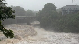 A view of the rising water levels at the Wainaku Street Bridge in Hilo on the Big Island of Hawaii, Saturday, Aug. 15, 2026.