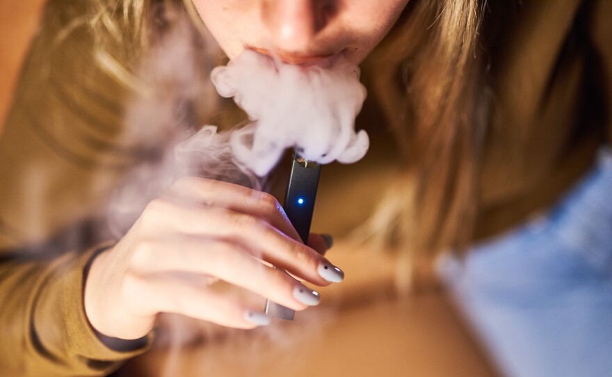 A person smokes a Juul Labs Inc. e-cigarette in a photograph taken in New York, last year.