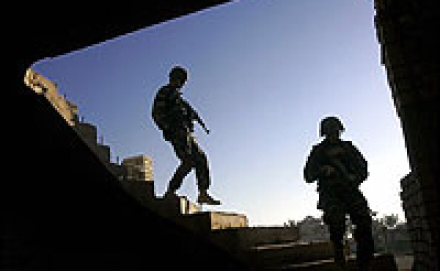 Iraqi police commandos search a house in Ramadi on Friday.