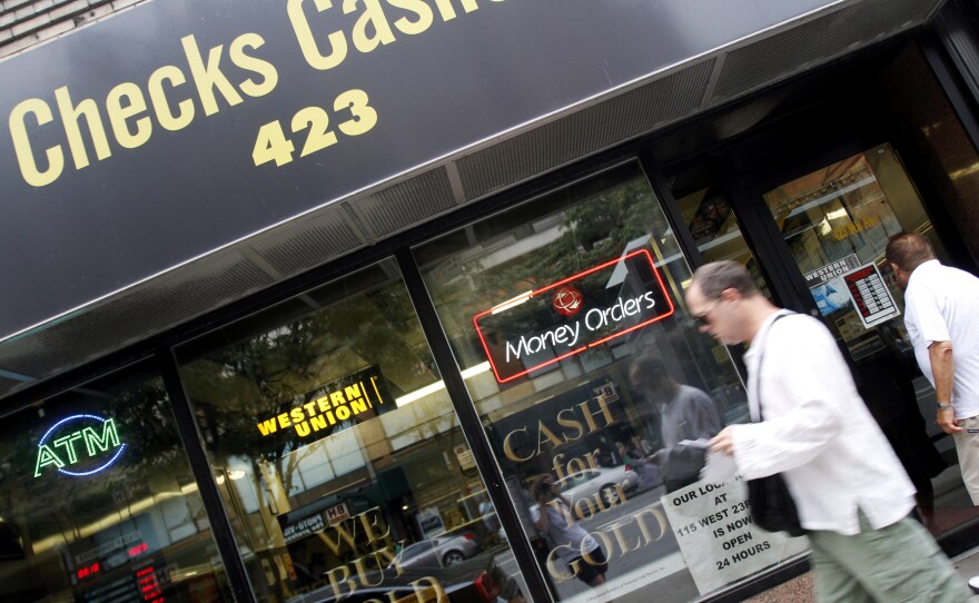 Millions of people who rely on check-cashing stores, like this one in New York City, could run into trouble buying health insurance.