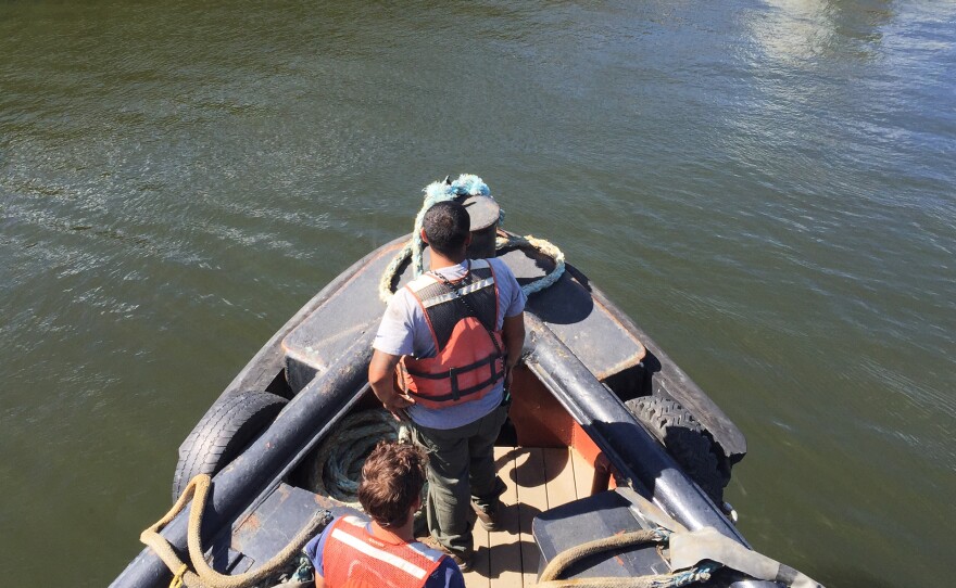 Deckhands Tony Awed (top) and Ed Pattison prepare to connect the tugboat Margot to the barge it will push up the Hudson River and along the Erie Canal.