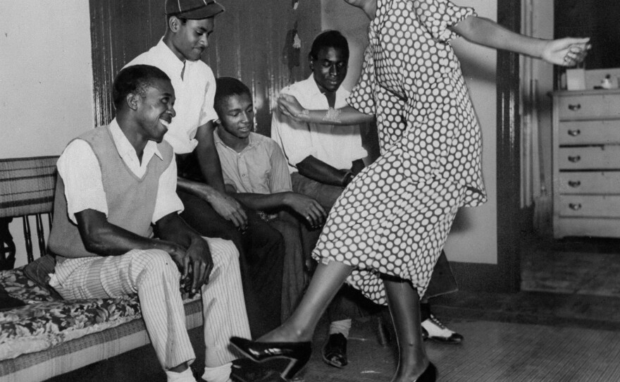 Edith Matthews shows friends and family how she won first place in the Lindy Hop in 1935.