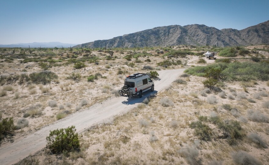 Aerial view showing an overlanding vehicle making its way through the Baja terrain, Mexico.