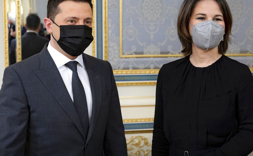 In this photo provided by Ukrainian Presidential Press Office, Ukrainian President Volodymyr Zelenskyy, left, and German Foreign Minister Annalena Baerbock pose for a photo during their meeting in Kyiv, Ukraine, Monday, Jan. 17, 2022.