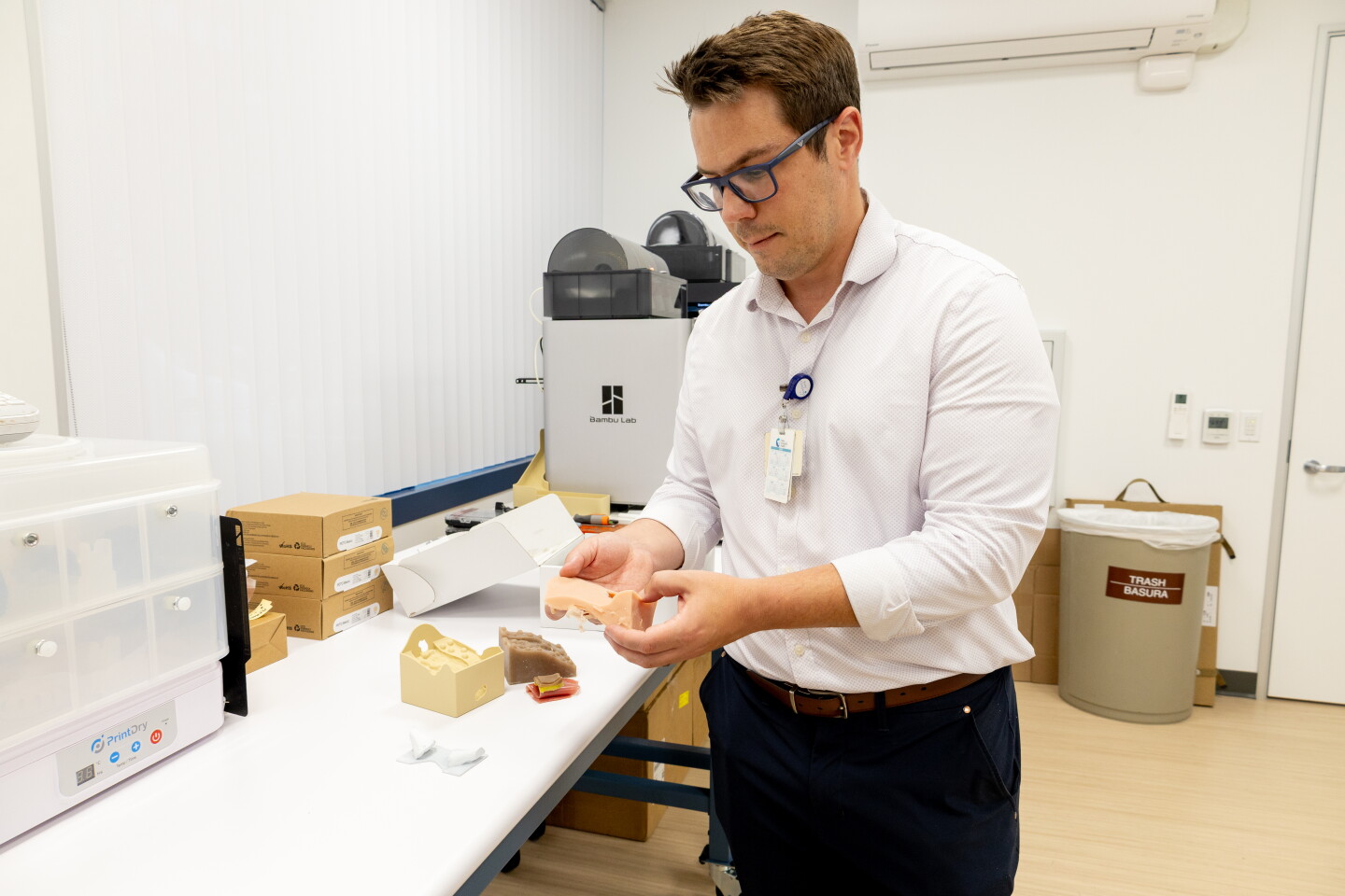 Justin Ryan holds a 3D-printed throat used in medical school tracheotomy demonstrations at Rady Children’s Hospital, Webster Foundation 3D Innovation Lab on August 6, 2026.
