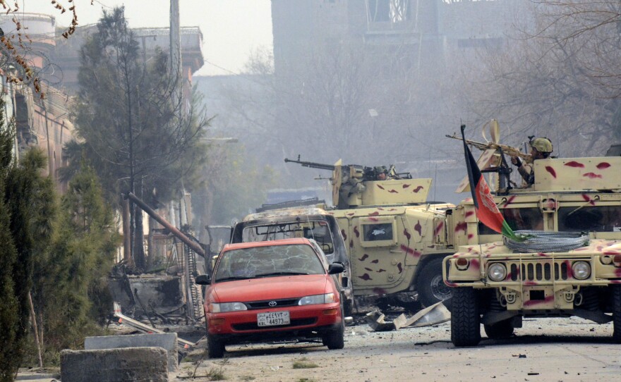 Afghan security personnel arrive after an attack on the office of Save the Children in Jalalabad, Afghanistan.