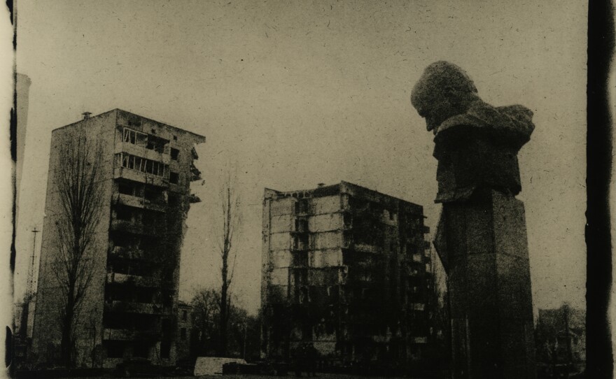 A monument to the poet Taras Shevchenko sits in front of ruined buildings in the city of<em> </em>Borodyanka, Ukraine, in March.