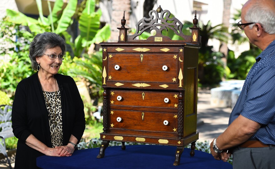 Ken Farmer (right) appraises an 1881 folk art child’s chest of drawers in San Antonio, Texas. ANTIQUES ROADSHOW “Kids Stuff” airs Monday, November 3 at 8/7C PM on PBS.