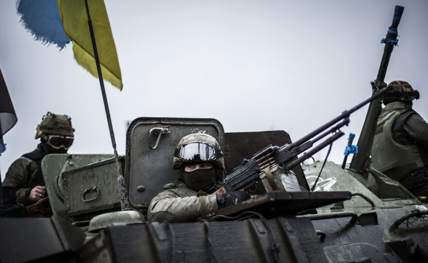 Ukrainian soldiers are seen in an armored vehicle topped with a Ukrainian flag near the city of Artemivsk, in the Donetsk region, on Sunday.