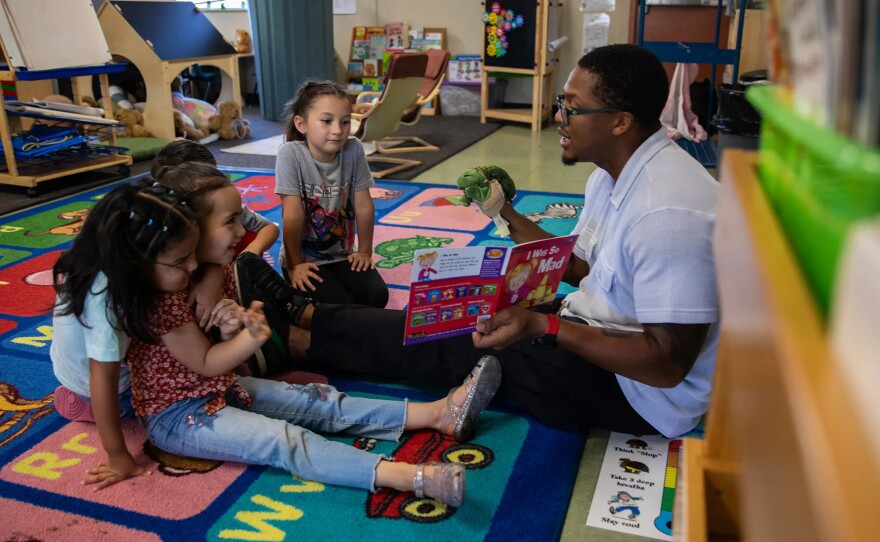 Therapist Spencer Mattox reads a book to students during a small group therapy session at Mi Escuelita in San Diego on May 20, 2025.