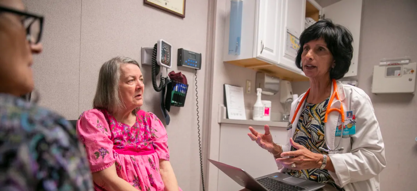 Nurse practitioner Surani Hayre-Kwan, right, speaks with patient Mary Valesano, left, and her caregiver Georgia Manolakos-Fraley, during a check-up at the Russian River Health Center in 2020.
